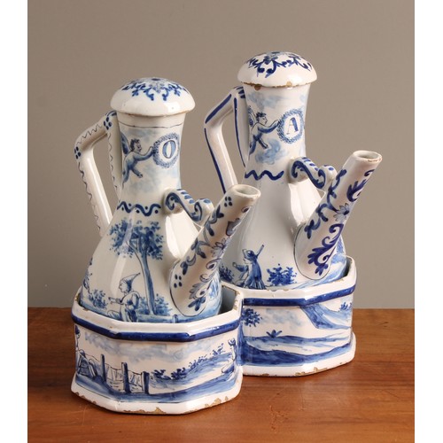 1009 - A Continental Delft oil and vinegar cruet set, comprising two bottles and a stand, the bottles 17.5c... 