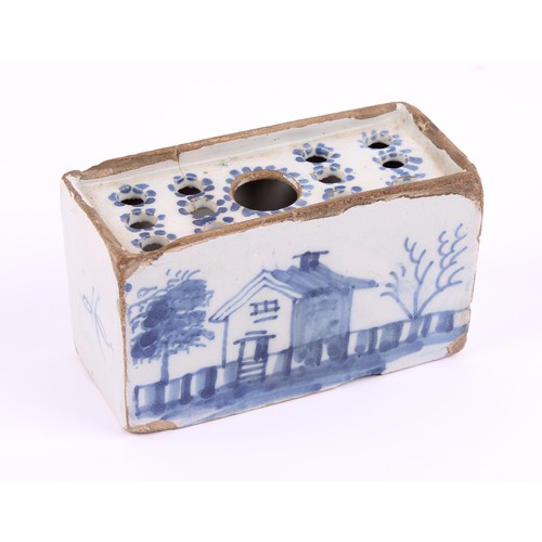 787 - An 18th century English Delft flower brick, probably Liverpool, decorated with a house, fence and tr... 
