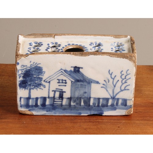 787 - An 18th century English Delft flower brick, probably Liverpool, decorated with a house, fence and tr... 