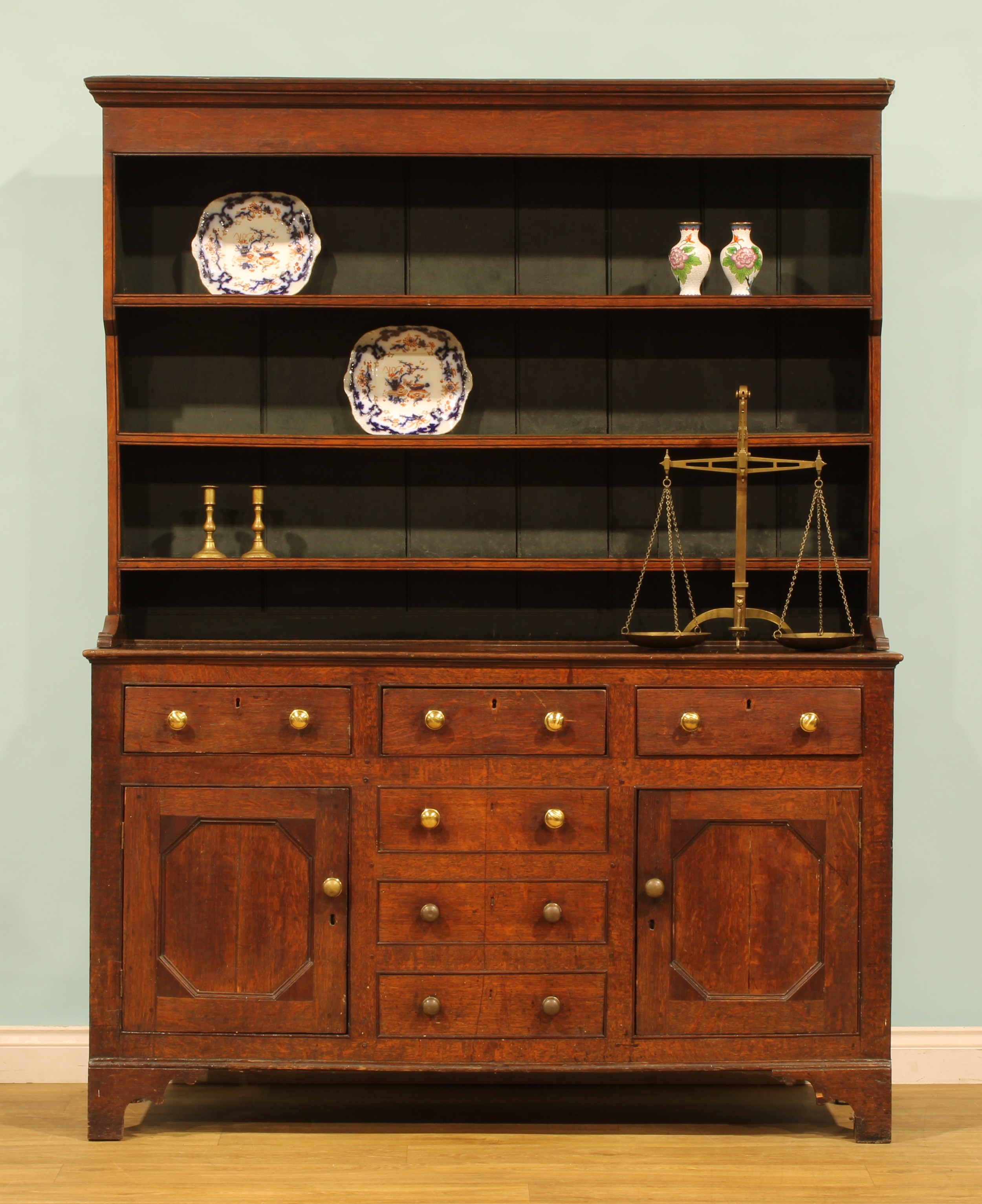 A George III oak dresser, moulded cornice above three plate rack ...