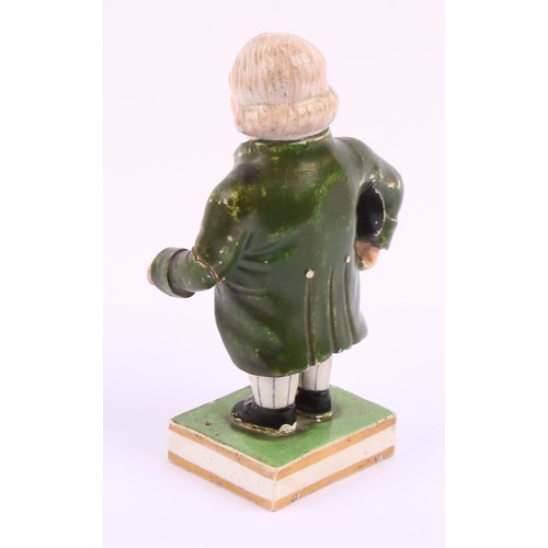 A Derby porcelain figure, of a portly gentleman, he stands wearing a ...