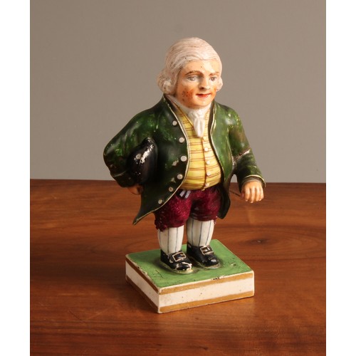 A Derby porcelain figure, of a portly gentleman, he stands wearing a ...