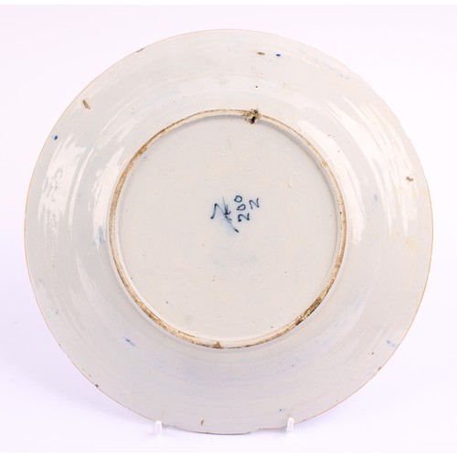 780 - A pair of 18th century Dutch Delft circular plates, painted in tones of blue with vases of flowers a... 