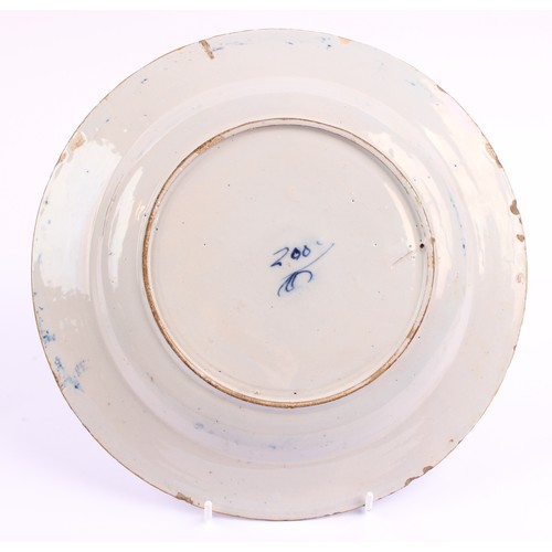 780 - A pair of 18th century Dutch Delft circular plates, painted in tones of blue with vases of flowers a... 