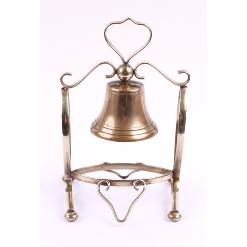 55 - An early 20th century E.P.N.S table bell, scroll frame, bun feet, 26cm high, c.1920