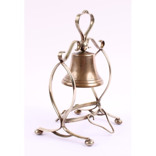 55 - An early 20th century E.P.N.S table bell, scroll frame, bun feet, 26cm high, c.1920