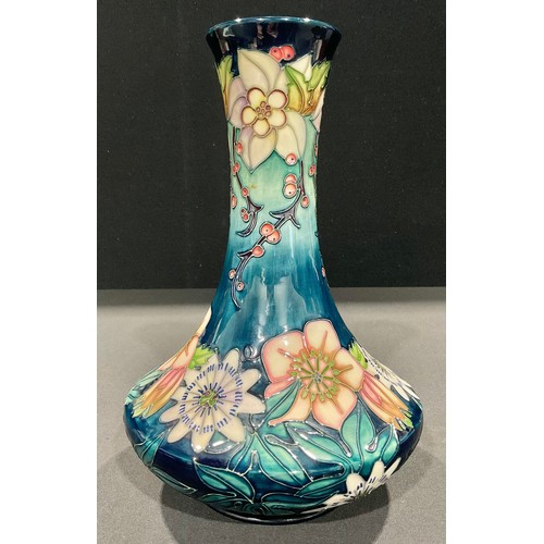 5013 - A Moorcroft bottle vase, Carousel pattern, designed by Rachel Bishop, tube lined with flowers on a g... 