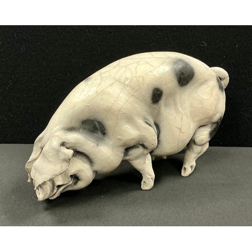 5022 - Studio of Christine Cummings (1969-2023) a raku sculpture of a Spotted Sow Pig, incised JB mark, 11.... 