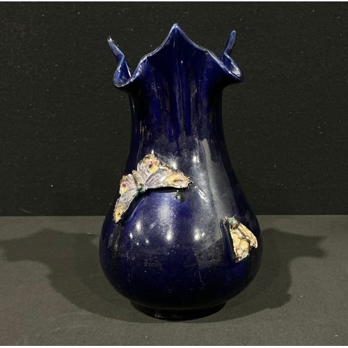 5035 - A Bretby Pottery flared baluster vase designed by Henry Tooth, applied in relief with three moths gl... 