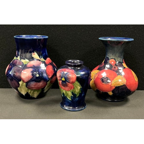 5055 - A Moorcroft Pomegranate pattern baluster vase, tube lined with pomegranates and berries, in autumnal... 