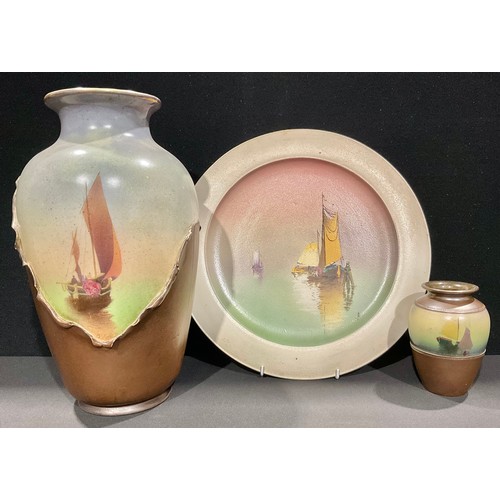 5064 - A Bretby Pottery tall shoulder vase, printed and painted with a sail boat emerging from mists, the b... 