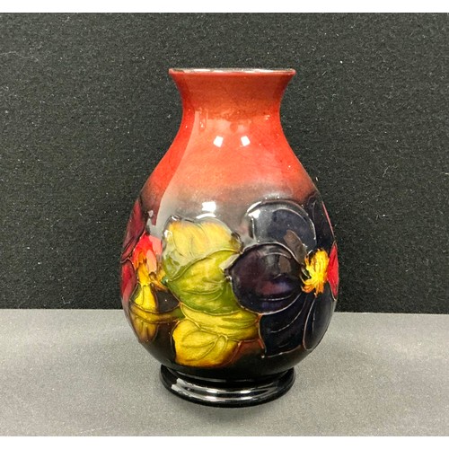 5076 - A Moorcroft flambe Clematis pattern ovoid vase, tube lined with leafy flowerheads in tones of red an... 
