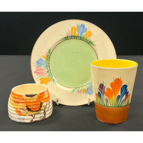 5088 - A Clarice Cliff Bizarre Crocus pattern beaker, painted with flowers on a honeyglaze ground, 9cm, pri... 