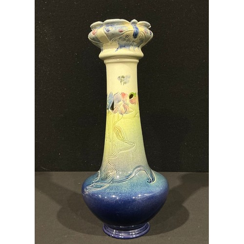5100 - A Bretby Pottery slender tapering bottle vase, incised with trailing flowers and butterflies, painte... 