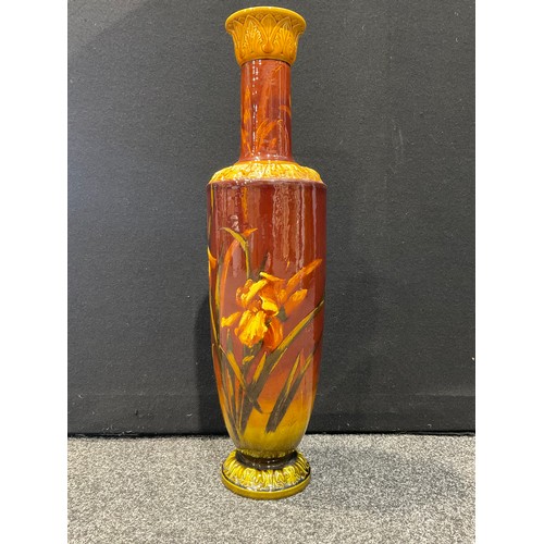 5116 - A Bretby Pottery tall floor standing vase, signed, impasto glazed with yellow Flag Irises on an ombr... 