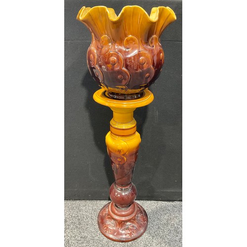 5115 - A Bretby Pottery jardinière on stand, after a design by Christopher Dresser (1834 - 1904) moulded wi... 