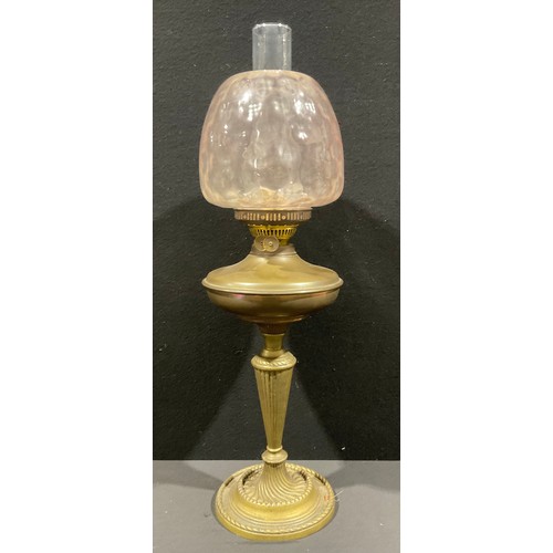 5582 - A brass oil lamp, twin burner, moulded glass shade in pale lilac, chimney flute, 66cm