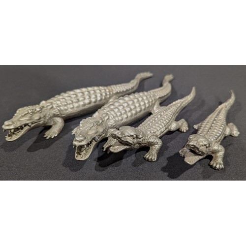 5586 - A group of four oriental stylised pewter crocodile models, the longest 22cm (4)