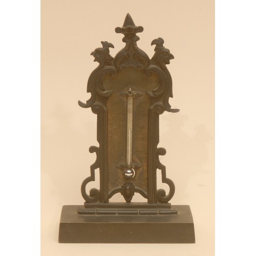 5587 - A 19th century Gothic Revival bronze desk thermometer, cast with scrolls and grotesque masks, rectan... 