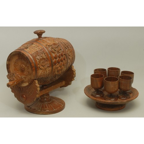 5589 - A Bulgarian carved treen handcrafted wine barrel, with accompanying set of six turned treen wine gla... 