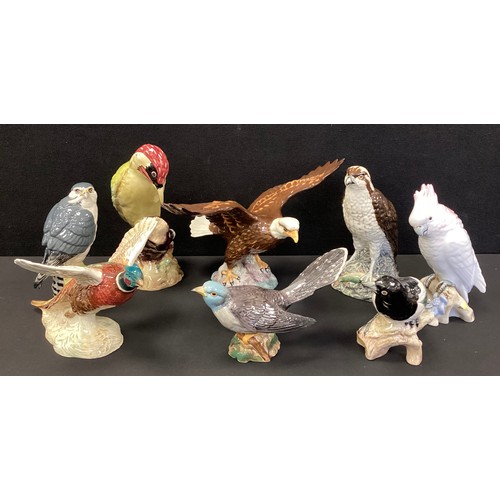 43 - Beswick model birds including, Magpie, Pheasant, Bald Eagle, others; a Royal Dux Cockatoo, 17cm high... 
