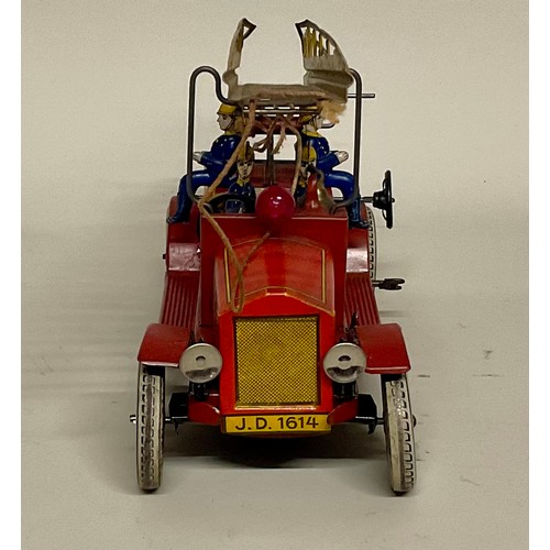 6001 - An early 20th century Distler (Germany) tinplate clockwork fire engine with electric light, four sea... 