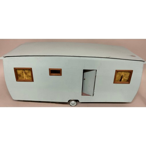 6046 - A scratch built child's model caravan, fitted with accessories and dolls, 34cm high, 80cm wide