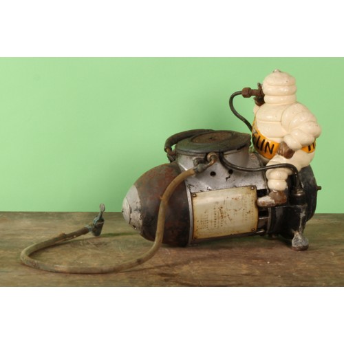 8023 - An early to mid 20th century 'MICHELIN' air compressor, mounted with a painted cast metal Bibendum f... 