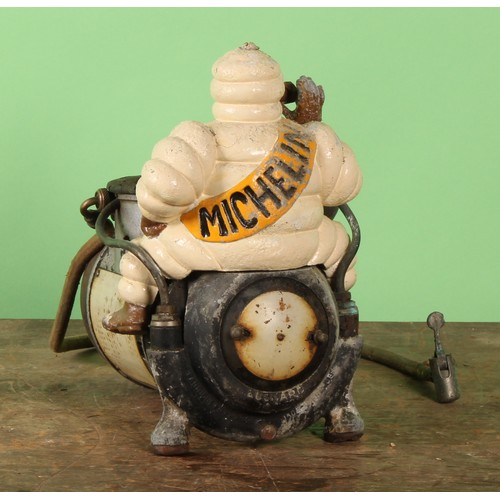 8023 - An early to mid 20th century 'MICHELIN' air compressor, mounted with a painted cast metal Bibendum f... 