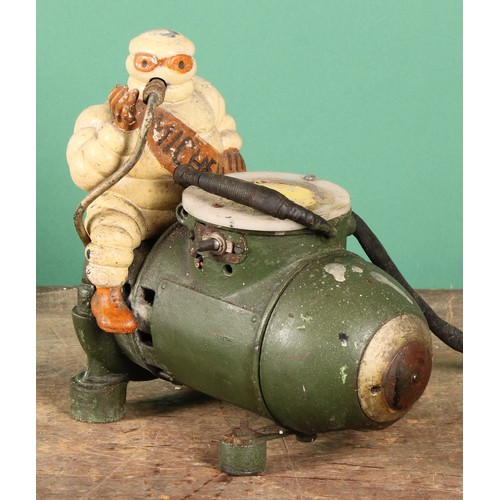 8024 - An early to mid 20th century 'MICHELIN' air compressor, mounted with a painted cast metal Bibendum f... 