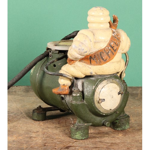 8024 - An early to mid 20th century 'MICHELIN' air compressor, mounted with a painted cast metal Bibendum f... 