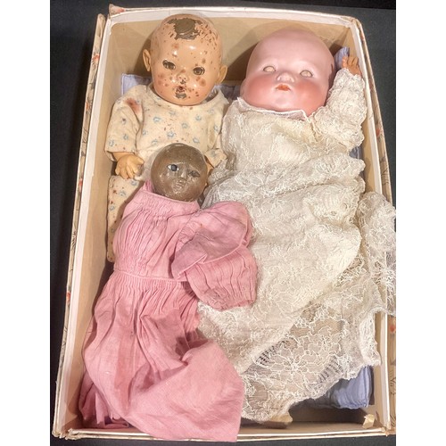 6040 - Dolls - A mixed group of three dolls, to include a carved wooden doll with painted features; Another... 
