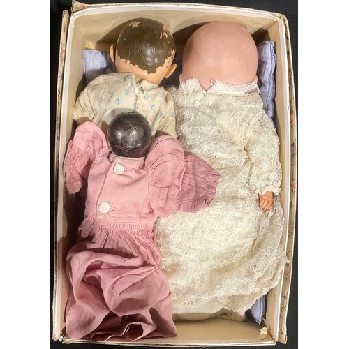 6040 - Dolls - A mixed group of three dolls, to include a carved wooden doll with painted features; Another... 