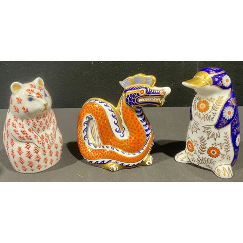 5063 - A Royal Crown Derby paperweight, Duckbilled Platypus, gold stopper, printed mark; others, Dragon, go... 