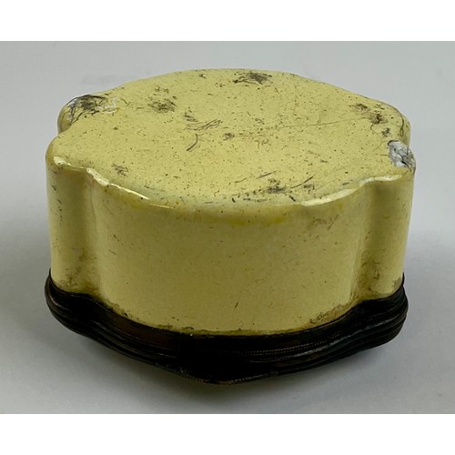 3046 - A George III South Staffordshire enamel and copper mounted snuff box, the shaped hinged cover painte... 
