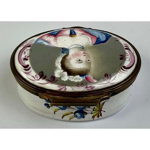 3035 - A George III South Staffordshire enamel and brass mounted oval snuff box, the hinged cover painted w... 
