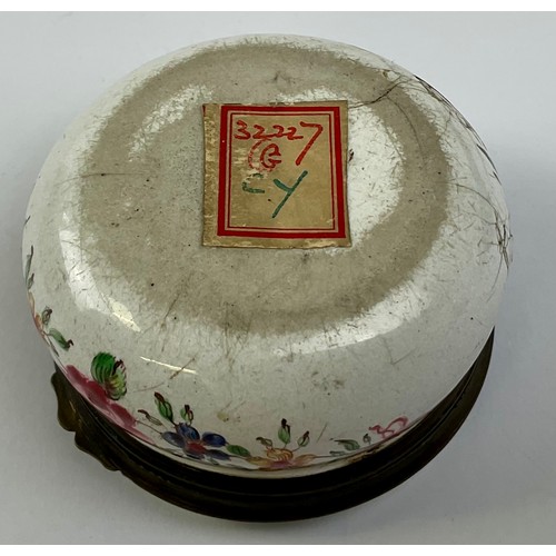 3032 - A George III South Staffordshire enamel and brass mounted circular snuff box, the hinged cover paint... 