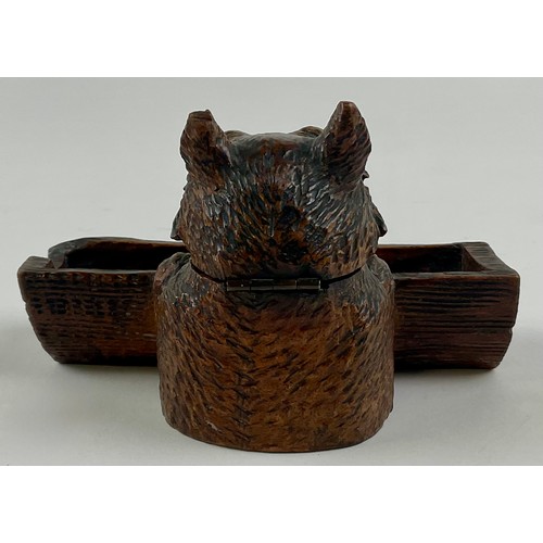 3000 - A Black Forest novelty inkwell, carved as a dog peering over a log, hinged cover, glass eyes, 12.5cm... 