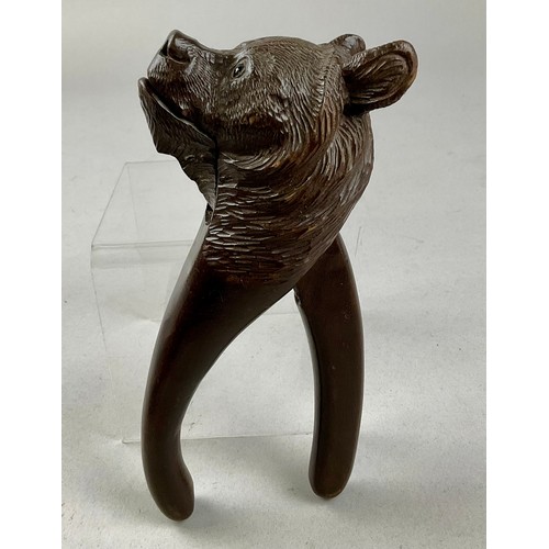 3001 - A Black Forest novelty lever-action nut cracker, carved as the head of a bear, glass eyes, 20.5cm lo... 