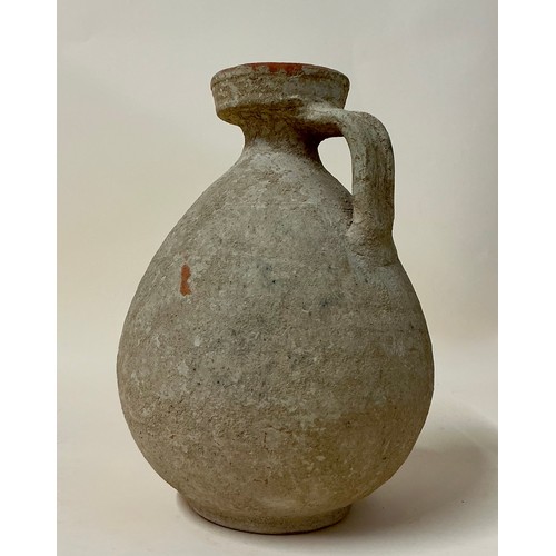 5057 - Antiquities - a Roman terracotta jug, everted rim, fluted handle, 21cm high overall, c. 1st-2nd AD
