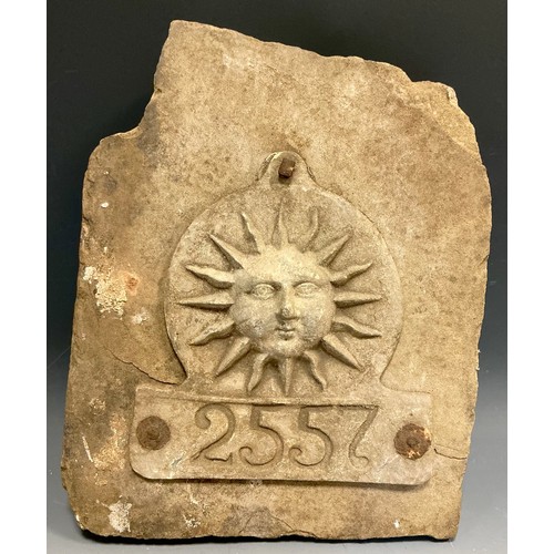 5004 - A lead The Sun Fire Office fire mark / plaque numbered 2557, mounted on a dressed gritstone slab, 29... 