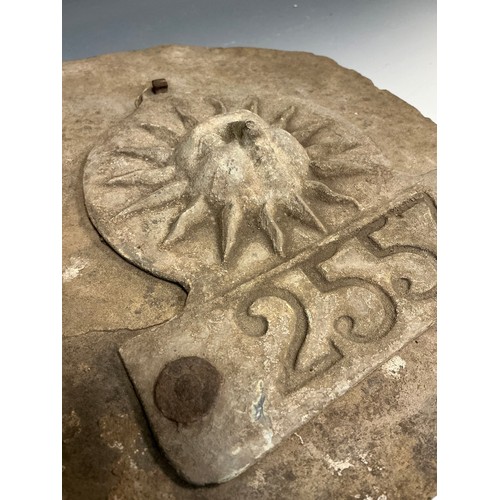 5004 - A lead The Sun Fire Office fire mark / plaque numbered 2557, mounted on a dressed gritstone slab, 29... 