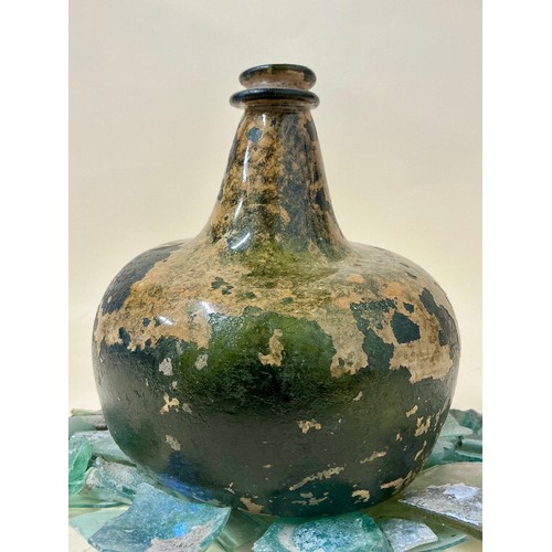 5000 - A late 17th/ early 18th century green glass onion bottle fragment, mottled brown patina; a collectio... 
