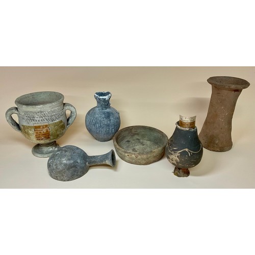 5058 - Antiquities - a small Romano-British Castor ware baluster shaped specimen vase, label to base readin... 