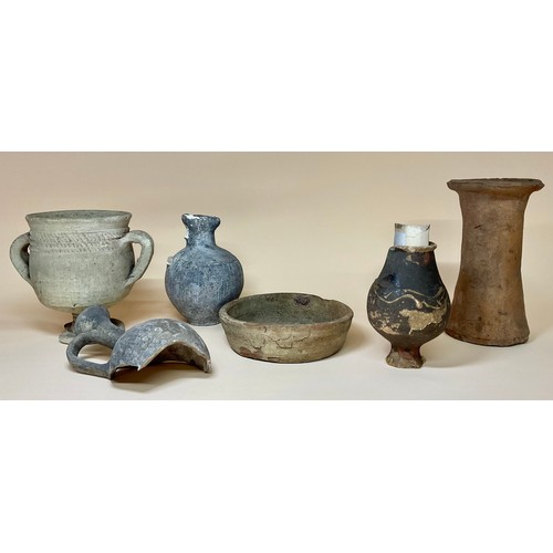 5058 - Antiquities - a small Romano-British Castor ware baluster shaped specimen vase, label to base readin... 