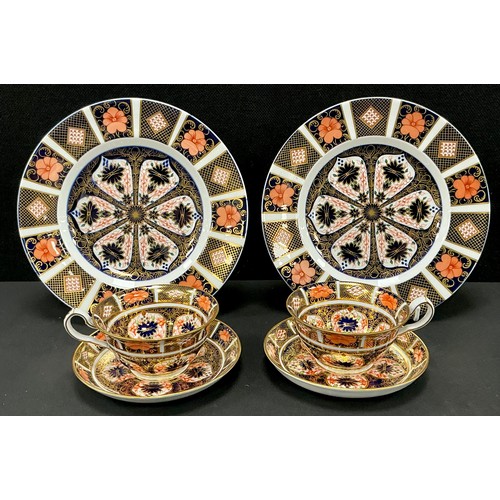 27 - Royal Crown Derby - an 1128 pattern pair of teacups and saucers, together with a tea plate (second) ... 