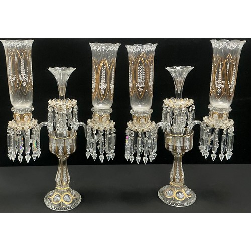 36 - A pair of elaborate garniture lustre candelabras, on shaped pedestal bases with two branches and bea... 