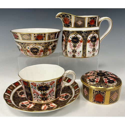 25 - A Royal Crown Derby Imari 1128 pattern milk jug and sugar bowl, printed marks in red, first quality;... 
