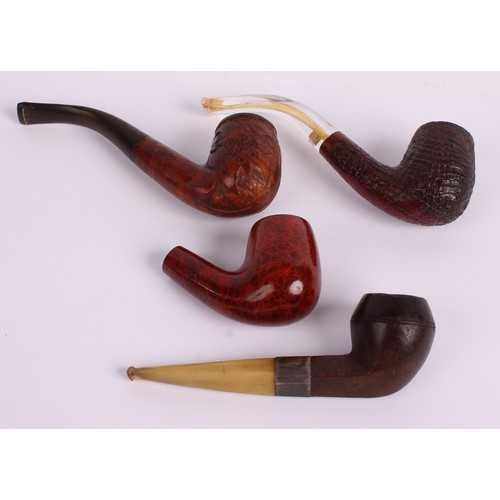 41 - A briar wood pipe, the bowl carved with floral motifs, 14cm long overall; others similar (4)