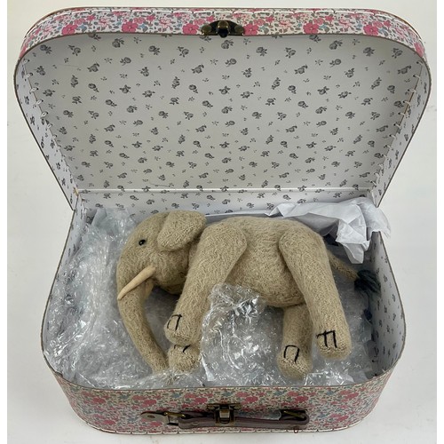 3037 - An early 20th century burlap plush jointed elephant, probably Steiff, boot button eyes, 15.5cm high,... 